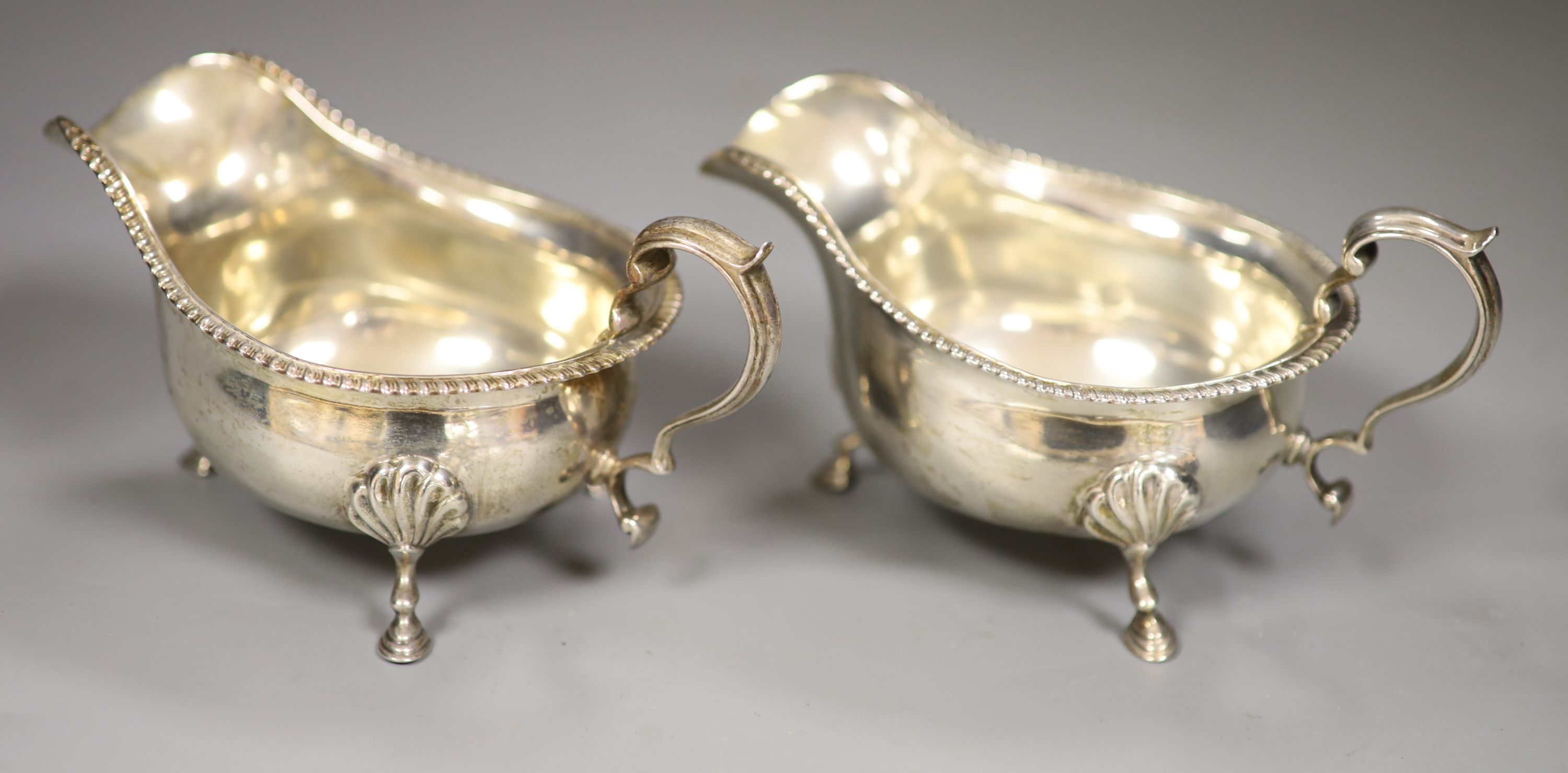 A pair of George V silver sauceboats, Goldsmiths & Silversmiths Co Ltd, London, 1910, height 8cm, 12oz.